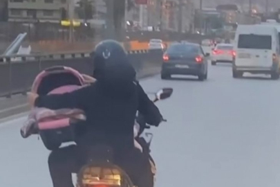 Bursa'da tehlikeli anlar! Bebeği böyle taşıdı
